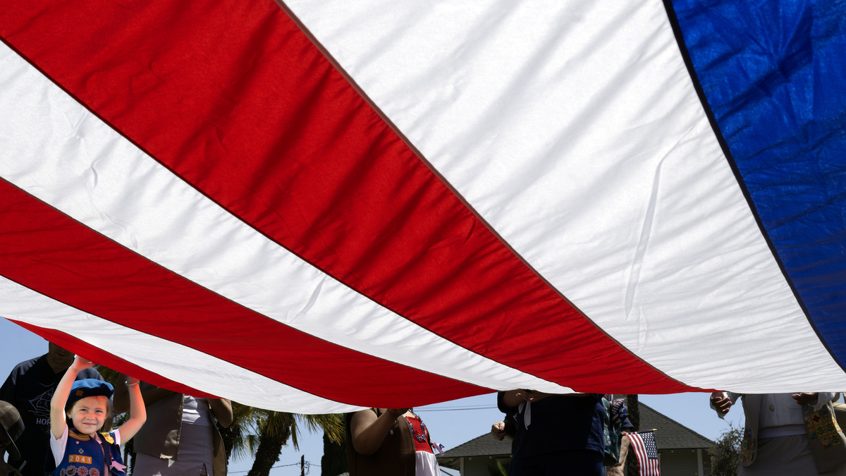 Four-year-old Remington Rivas holds Old Glory high as she and other Girl Scouts get ready to march in Anaheim’s 31st annual Flag Day parade on Sunday, June 14, 2026. (Photo by Mindy Schauer, Orange County Register/SCNG)