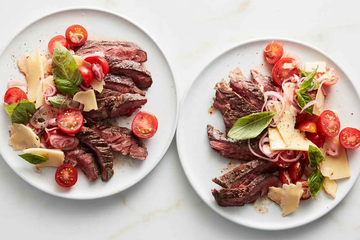 Grilled steak with tomatoes, basil and cheddar. A steak dinner is worthy of occasion. Make it well with Ali Slagle's tips. Food Stylist: Rebecca Jurkevich. (Johnny Miller/The New York Times)