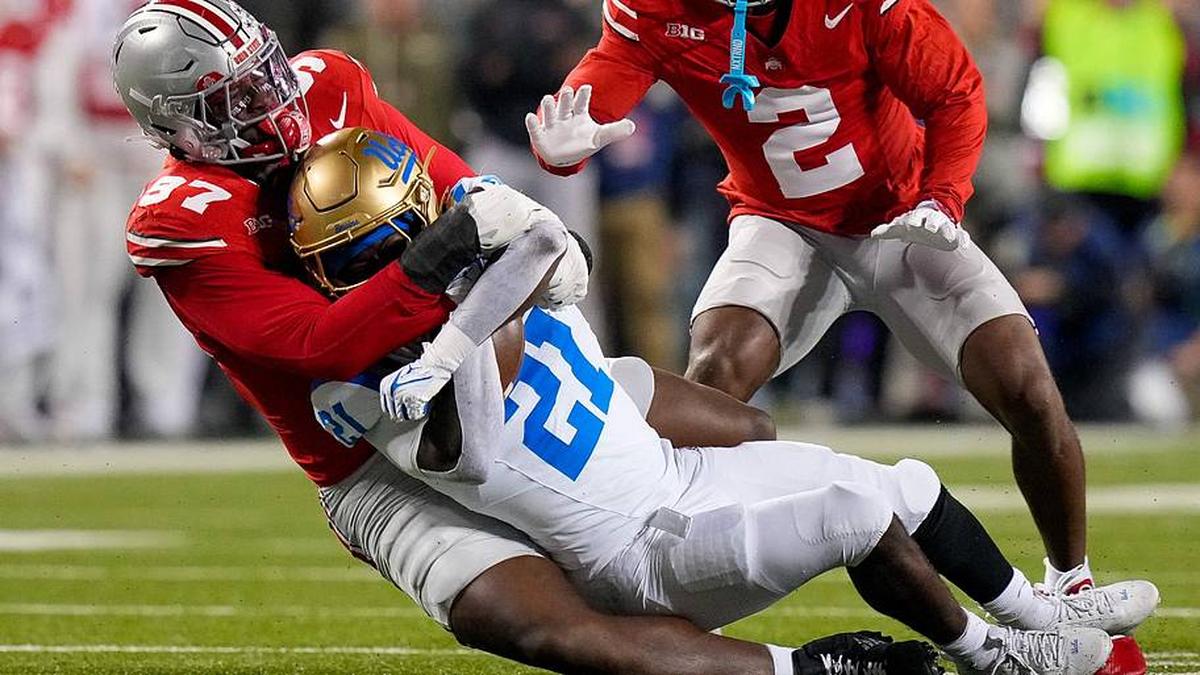  Ohio State Buckeyes defensive end Kenyatta Jackson Jr. (97) tackles UCLA Bruins running back Jaivian Thomas (21) in the first half of the NCAA college football game at Ohio Stadium on Saturday, Nov. 15, 2025 in Columbus, Ohio. | Samantha Madar/Columbus Dispatch / USA TODAY NETWORK via Imagn Images 