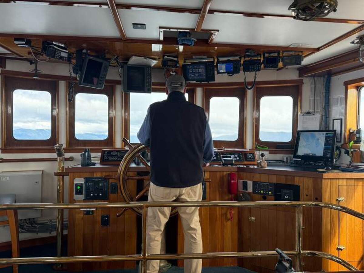 Captain Jim Jefferson guiding the Mist Cove through the waterways of Alaska’s Tongass National Forest. Photo credit: Mimi Slawoff 