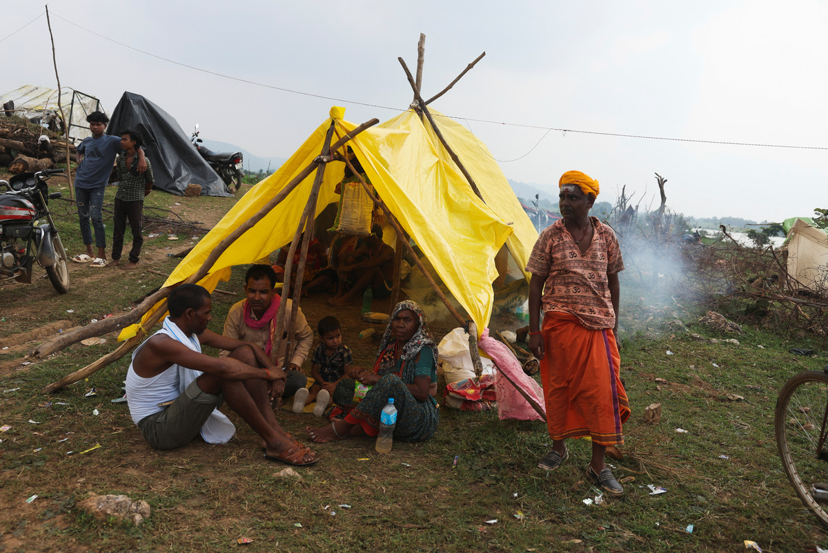 As rising waters flood homes and temples, villagers protest India's $87 ...