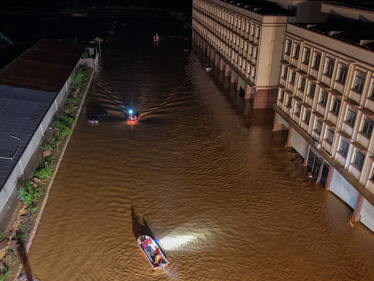 A drone view shows rescue workers navigating boats through floodwaters after heavy rainfall brought by typhoon Maysak, in Hengzhou, Guangxi Zhuang Autonomous Region, China July 6, 2026. China Daily via REUTERS