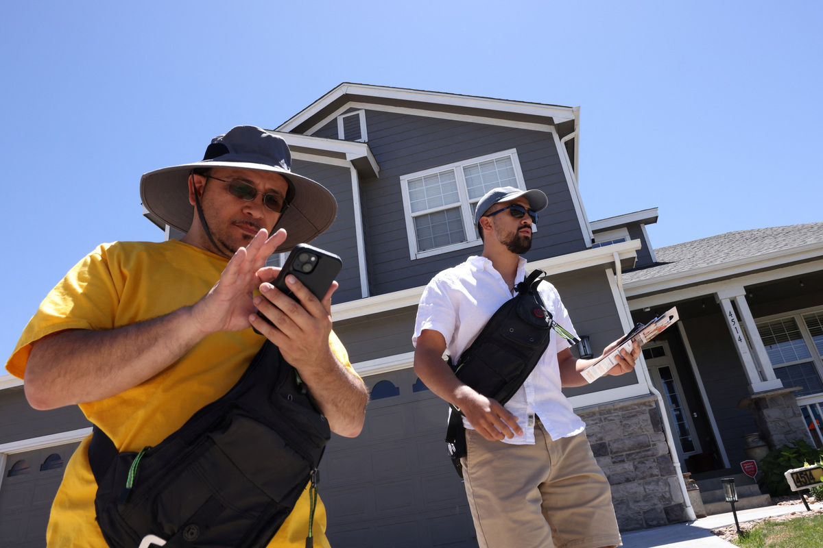 Gerard Torrez, left, and Angel Merlos of the right-leaning grassroots political organization, The LIBRE Initiative, go door-to-door seeking voters who will support U.S. Rep. Gabe Evans (R-CO) for the midterm elections, in Brighton, Colorado, U.S., June 11, 2026. REUTERS/Kevin Mohatt