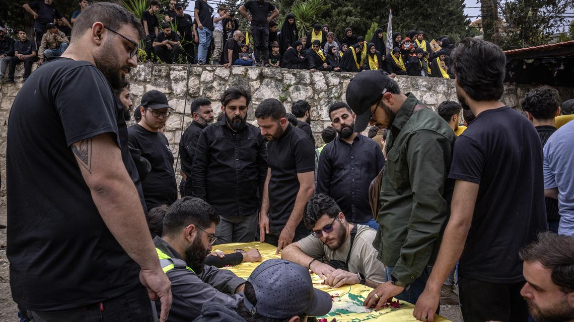 Hezbollah vows to keep weapons as Lebanon says Israeli strikes kill 14