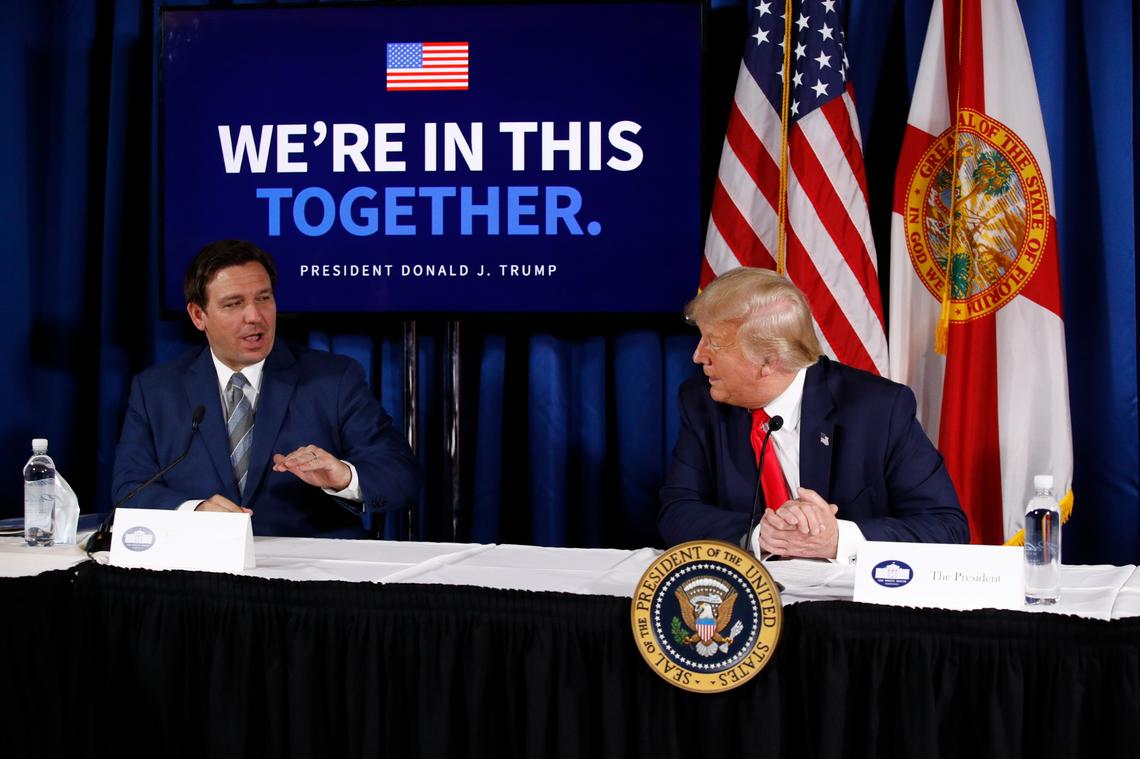 President Donald Trump speaks with Florida Gov. Ron DeSantis during a roundtable discussion on the coronavirus outbreak and storm preparedness at Pelican Golf Club in Belleair, Fla., on July 31, 2020.