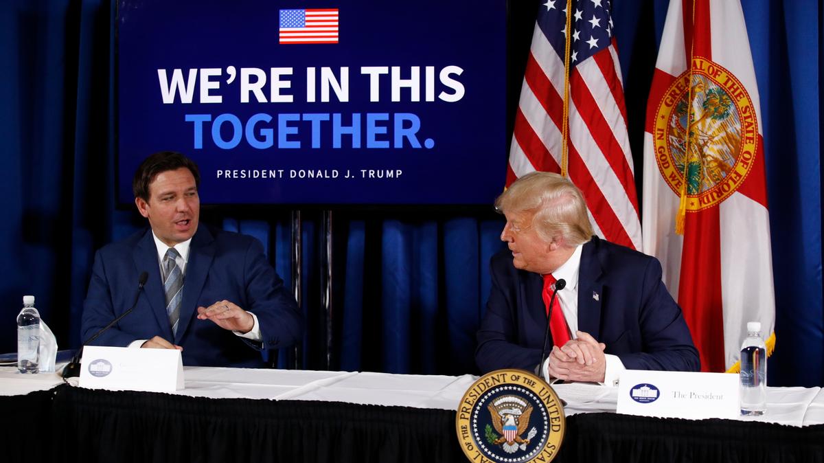 President Donald Trump speaks with Florida Gov. Ron DeSantis during a roundtable discussion on the coronavirus outbreak and storm preparedness at Pelican Golf Club in Belleair, Fla., Friday, July 31, 2020.