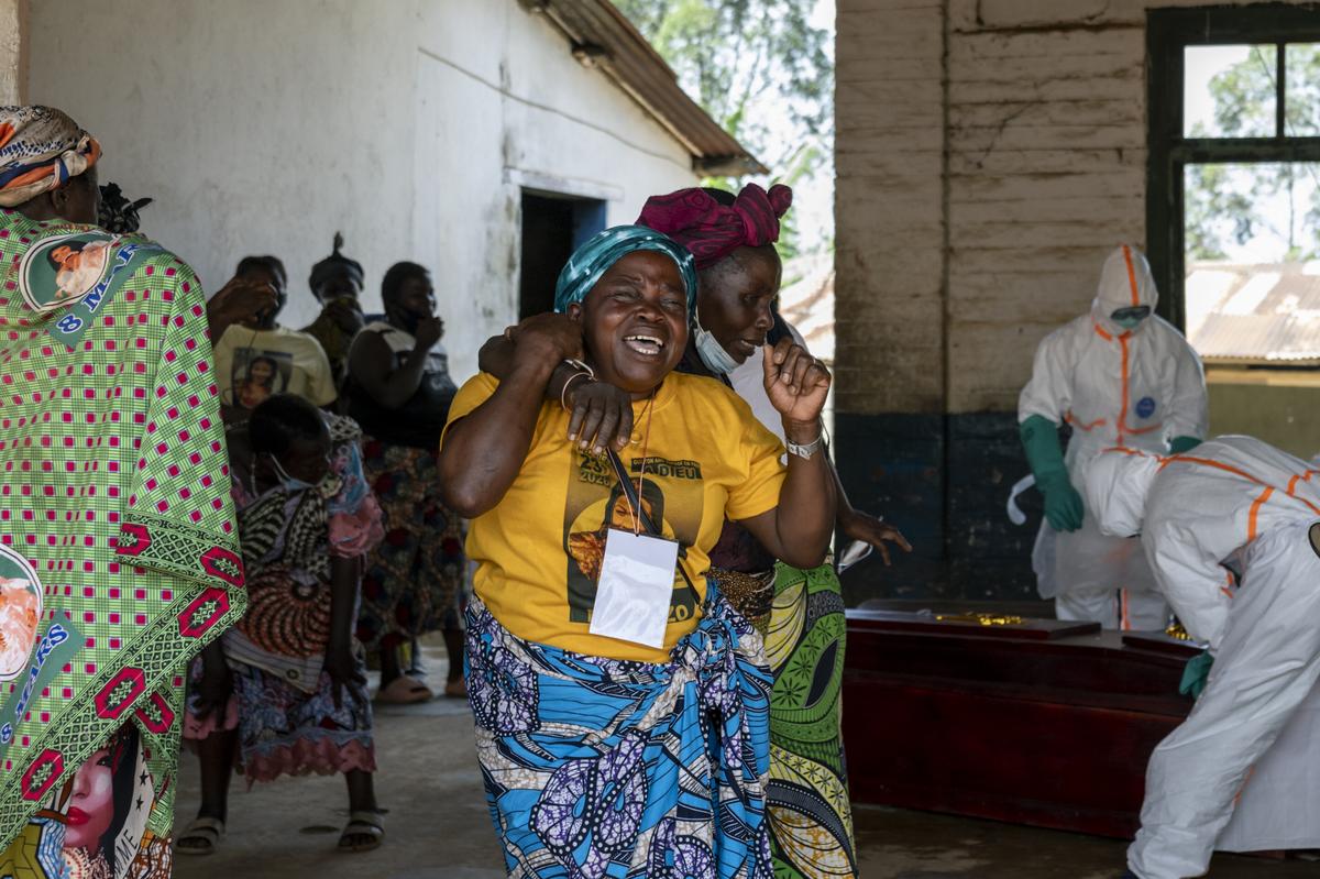 Relatives react as health workers placed Christiane Bahati's body into a coffin at a hospital's Ebola ward in the mining town of Mongbwalu, Democratic Republic of Congo, May 27, 2026. In a remote gold mining town at the epicenter of the Ebola outbreak, medical workers struggle to beat back a surge of deaths and infections. (Arlette Bashizi/The New York Times)