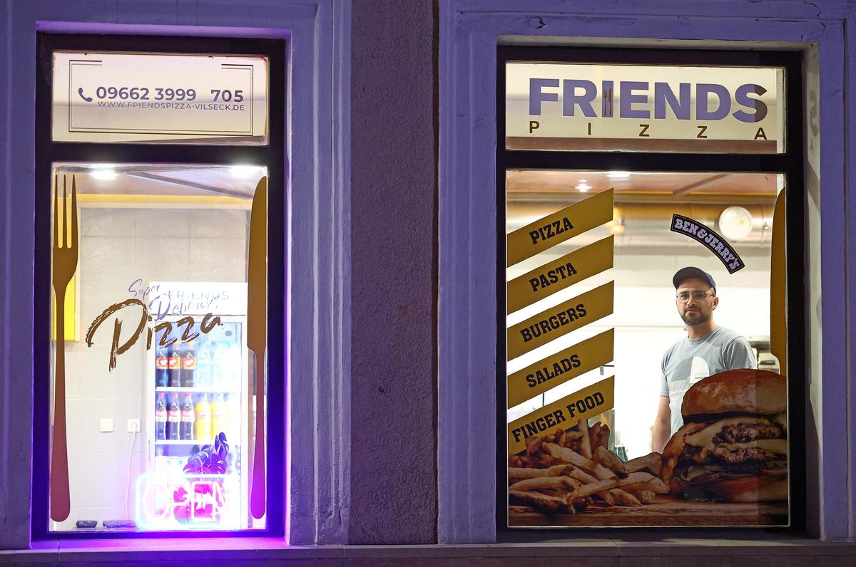 Fatmir Fazliji, 40, owner of Friends Pizza, looks out the window of his diner in Vilseck, Germany, May 4, 2026. “If 5000 troops leave, it will affect everyone and that would be a downfall for the town. I have 90 percent American clients” said Fazliji. REUTERS/Lisi Niesner
