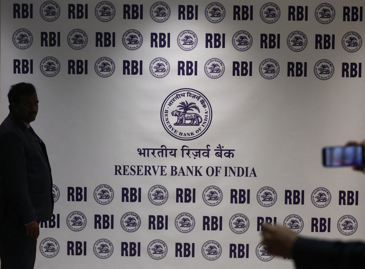 FILE PHOTO: A man stands in front of the Reserve Bank of India (RBI) logo inside its headquarters in Mumbai, India, February 6, 2026. REUTERS/Francis Mascarenhas/File Photo