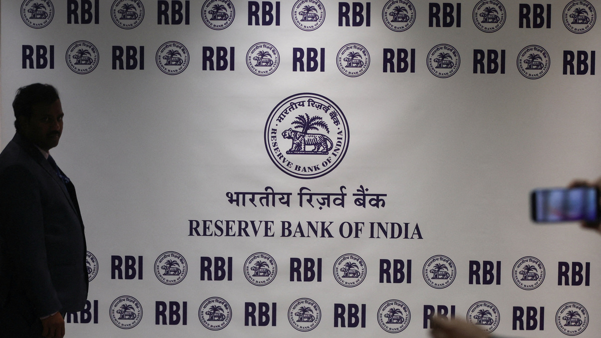FILE PHOTO: A man stands in front of the Reserve Bank of India (RBI) logo inside its headquarters in Mumbai, India, February 6, 2026. REUTERS/Francis Mascarenhas/File Photo
