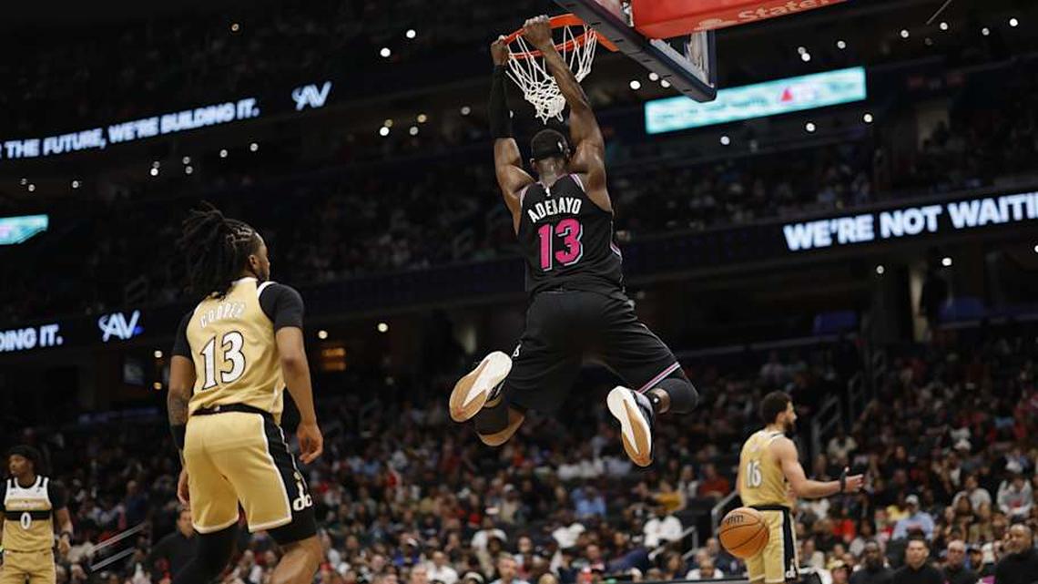  Apr 10, 2026; Washington, District of Columbia, USA; Miami Heat center Bam Adebayo (13) dunks the ball as Washington Wizards guard Sharife Cooper (13) looks on in the first half at Capital One Arena. Mandatory Credit: Geoff Burke-Imagn Images | Geoff Burke-Imagn Images 