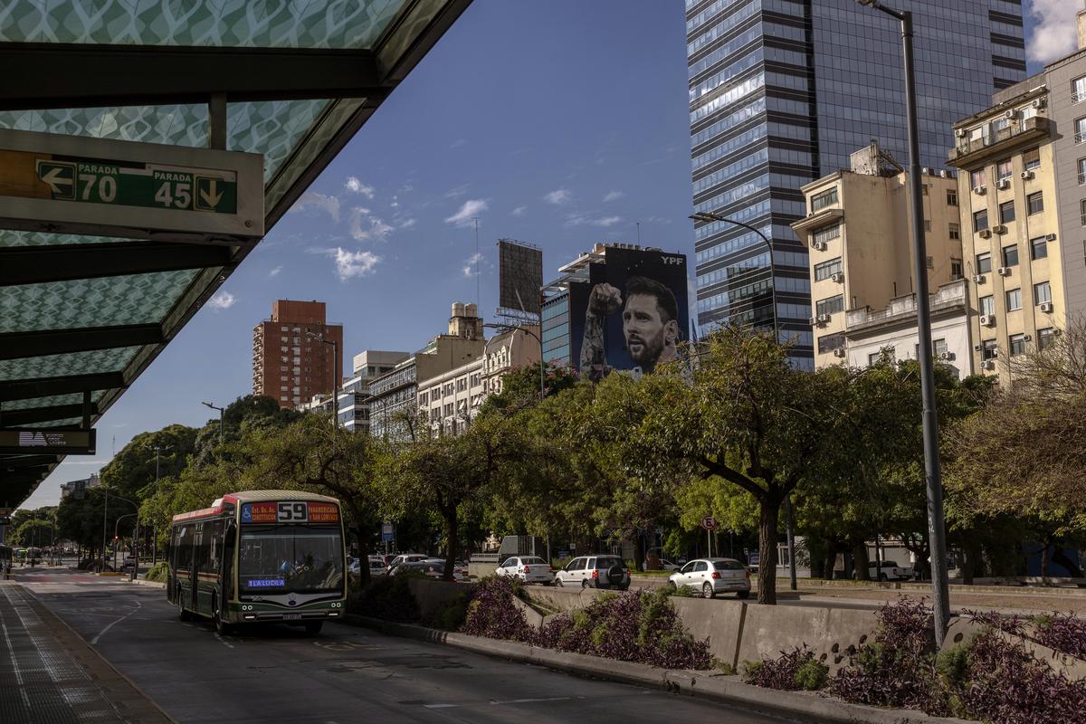 People in Buenos Aires, Argentina never seem to be far from a larger-than-life mural of the soccer star Lionel Mess, like the one seen here on April 25, 2026. Dynamic ticket pricing has made this year's World Cup tournament the most expensive in history, pushing Argentine fans to extremes. (Sarah Pabst/The New York Times)