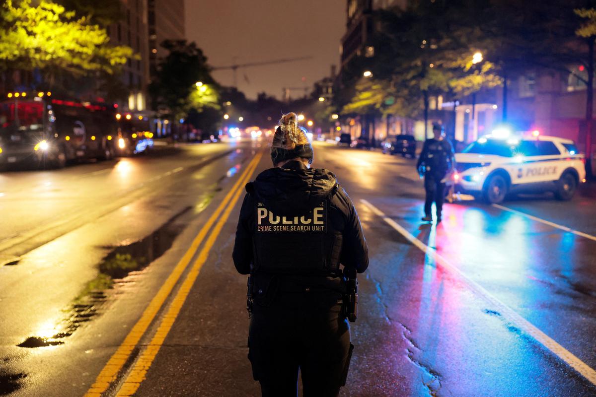 A law enforcement official stands near the scene, after a shooting incident near the White House, in Washington, , in Washington, D.C., U.S., May 23, 2026. REUTERS/Kylie Cooper