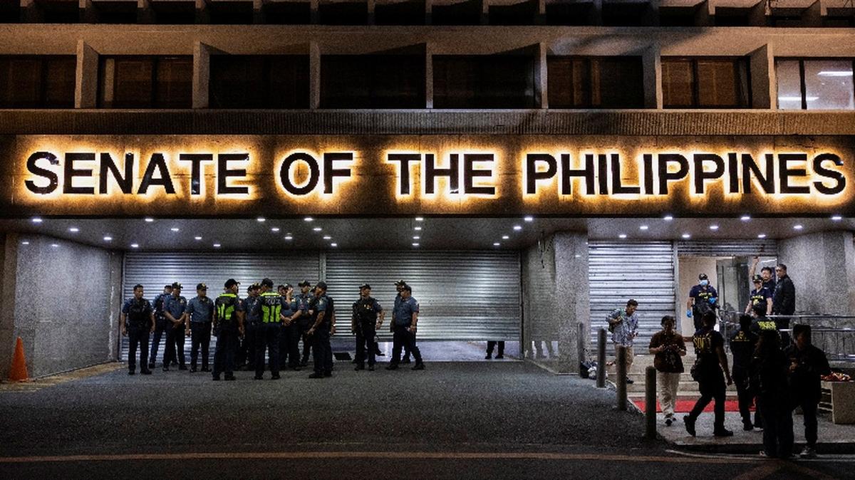 Police officers stand outside the Senate building, after gunshots were heard at the Philippine Senate, as chaos mounted in anticipation of an attempt to arrest a top senator wanted by the International Criminal Court, in Pasay City, Metro Manila, Philippines, May 13, 2026. REUTERS/Eloisa Lopez
