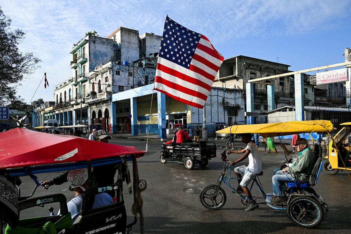 A tricycle used as a taxi is decorated with the U.S. flag in Havana. Yamil Lage/AFP via Getty Images 