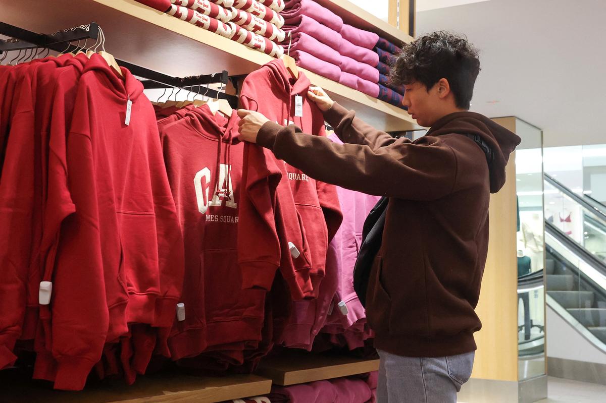 A person shops at a Gap store in Times Square in New York City, U.S., November 28, 2024. REUTERS/Brendan McDermid