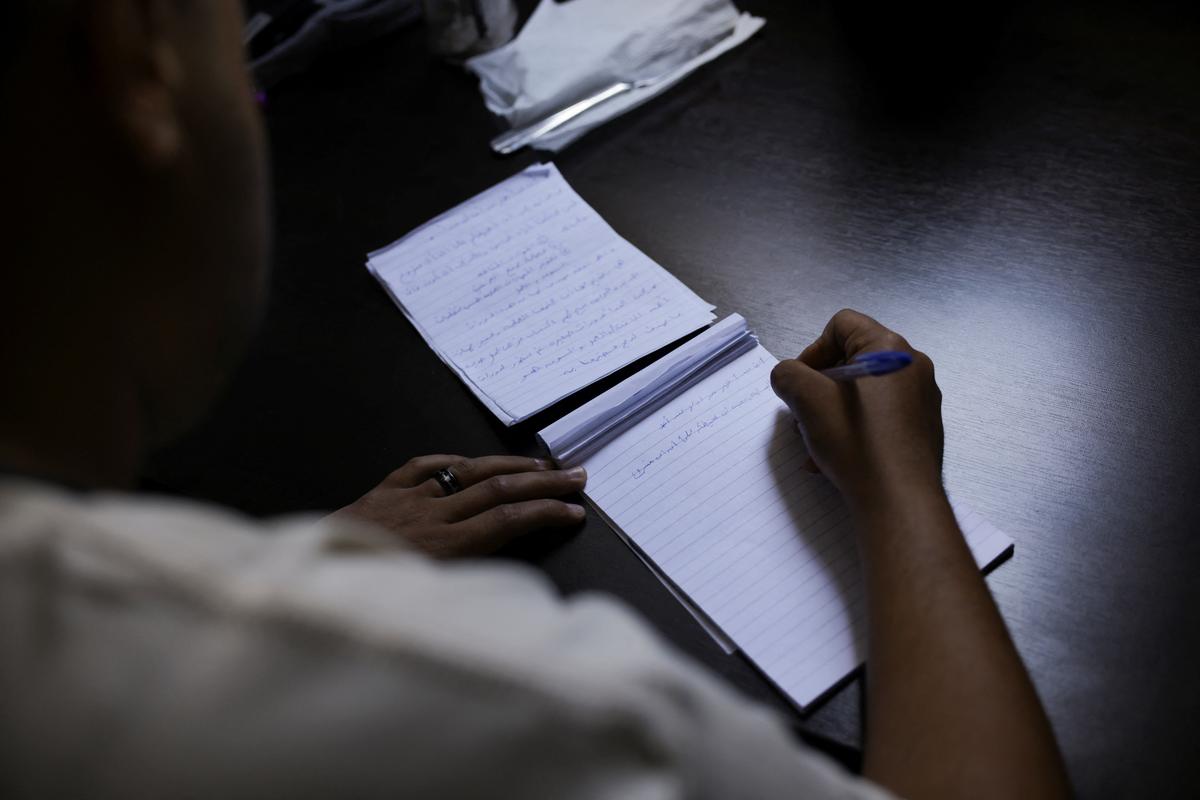 An Egyptian transgender man who escaped from Egypt due to persecution and asked to be identified by the name Mina for security reasons writes about his hopes in a temporary shelter for displaced people, in Beirut, Lebanon, May 4, 2026. REUTERS/Raghed Waked.