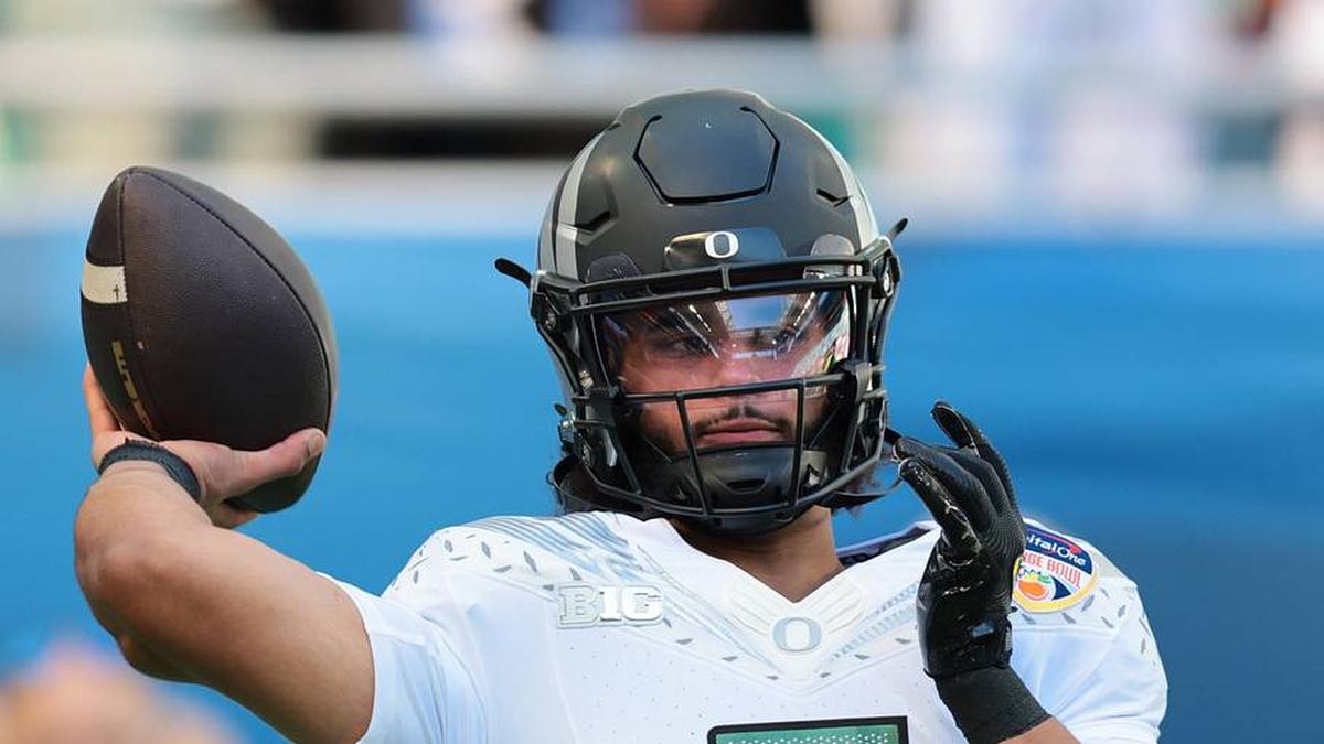  Jan 1, 2026; Miami Gardens, FL, USA; Oregon Ducks quarterback Dante Moore (5) warms up prior to the 2025 Orange Bowl and quarterfinal game of the College Football Playoff against the Texas Tech Red Raiders at Hard Rock Stadium. Mandatory Credit: Sam Navarro-Imagn Images | Sam Navarro-Imagn Images 