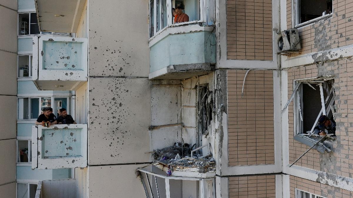 Residents clear debris from broken windows in a damaged apartment building following a Ukrainian drone attack in the course of Russia-Ukraine conflict in Krasnogorsk, in the Moscow region, Russia May 17, 2026. REUTERS/Stringer