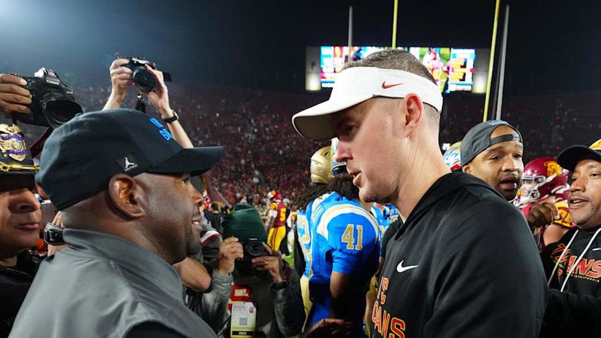  Nov 29, 2025; Los Angeles, California, USA; UCLA Bruins interim coach Tim Skipper (left) shakes hands with Southern California Trojans head coach Lincoln Riley after the game at United Airlines Field at Los Angeles Memorial Coliseum. Mandatory Credit: Kirby Lee-Imagn Images | Kirby Lee-Imagn Images 