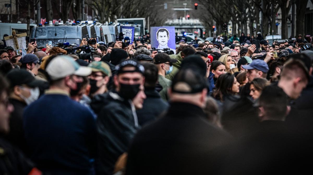 Protesters hold a portrait in tribute to far-right activist Quentin Deranque, who died after being attacked on the sidelines of a far-right protest against a La France Insoumise event at Sciences Po Lyon, in Lyon, France, on Saturday, Feb. 21, 2026. (Olivier Chassignole/AFP/Getty Images/TNS)