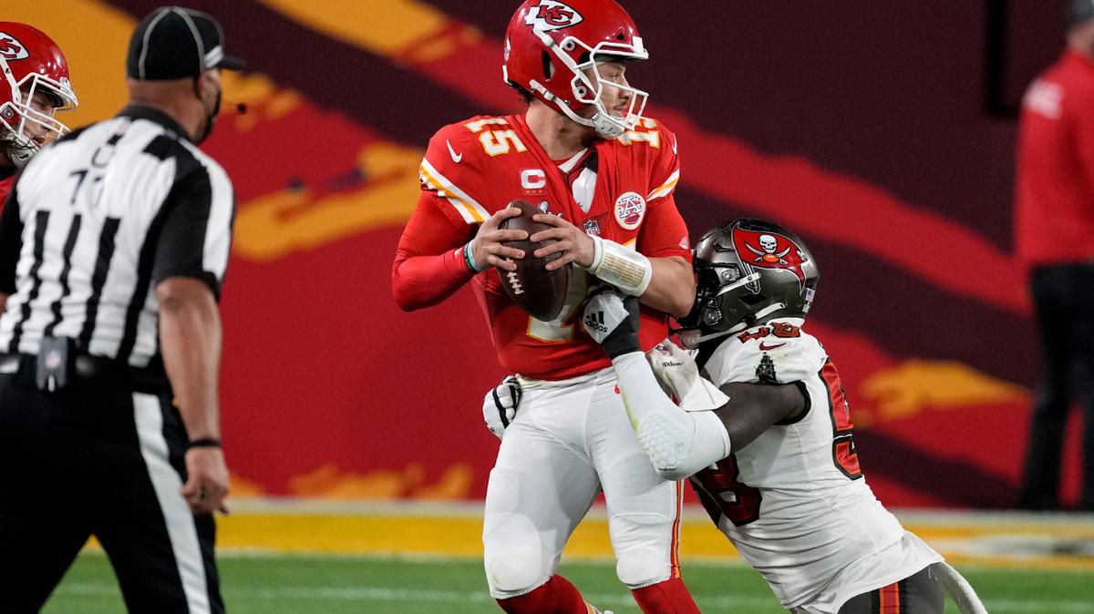 Kansas City Chiefs quarterback Patrick Mahomes (15) looks to throw a pass while in the grasp of Tampa Bay Buccaneers outside linebacker Shaquil Barrett, right, during the second half of the NFL Super Bowl 55 football game, Sunday, Feb. 7, 2021, in Tampa, Fla. (AP Photo/Chris O’Meara)