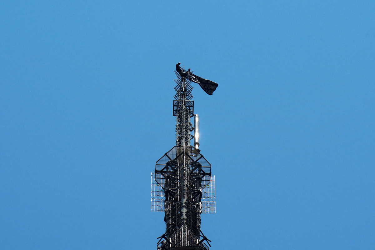 Two people display a banner as they stage a protest atop the Empire State Building in the Manhattan borough of New York, U.S., July 1, 2026.  REUTERS/Adam Gray