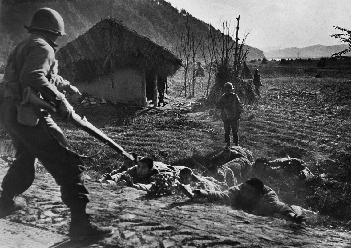  U.S. soldiers in 1951 order Chinese prisoners to the ground outside Seoul, South Korea, before U.S. and U.N. troops took the city. AFP via Getty Images 