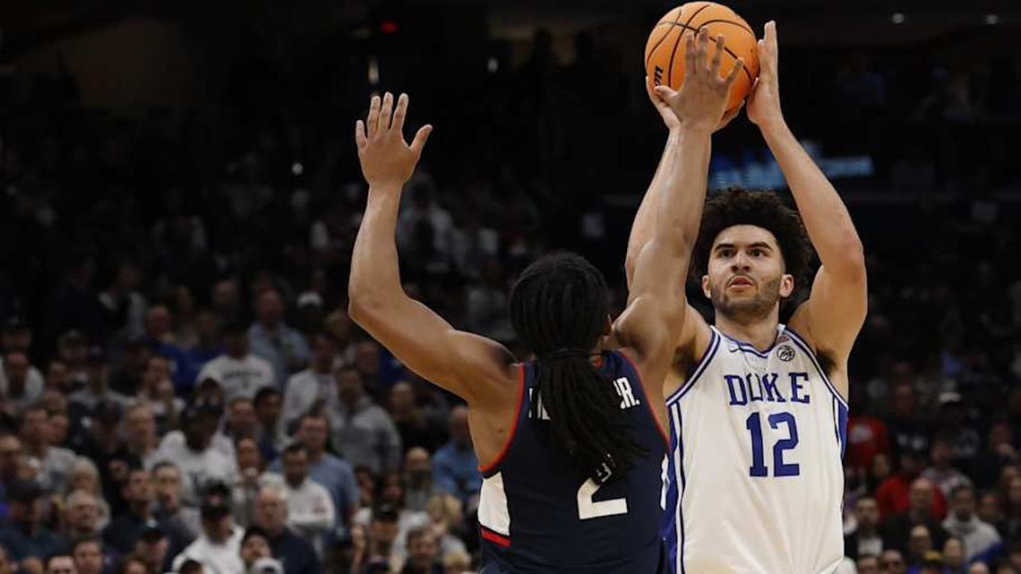  Mar 29, 2026; Washington, DC, USA; Duke Blue Devils forward Cameron Boozer (12) shoots the ball over UConn Huskies guard Silas Demary Jr. (2) in the second half during an Elite Eight game of the East Regional of the men's 2026 NCAA Tournament at Capital One Arena. Mandatory Credit: Geoff Burke-Imagn Images | Geoff Burke-Imagn Images 