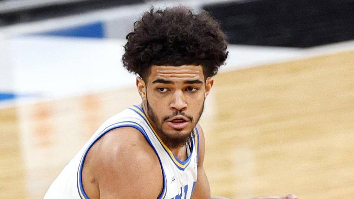  Mar 14, 2026; Chicago, IL, USA; UCLA Bruins guard Eric Freeny (8) brings the ball up court against Purdue Boilermakers center Daniel Jacobsen (12) during the first half at United Center. Mandatory Credit: Kamil Krzaczynski-Imagn Images | Kamil Krzaczynski-Imagn Images 