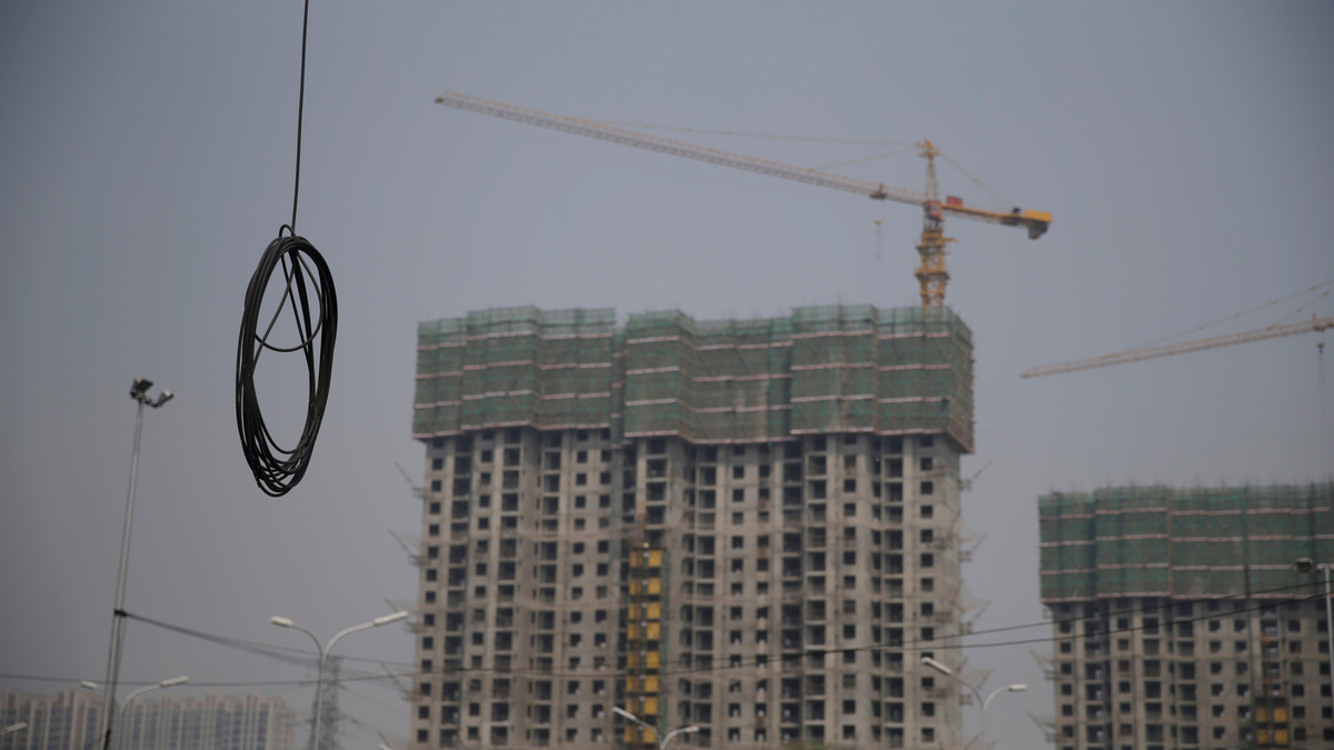 A cable is seen near residential buildings under construction in Beijing, China April 20, 2018. REUTERS/Jason Lee