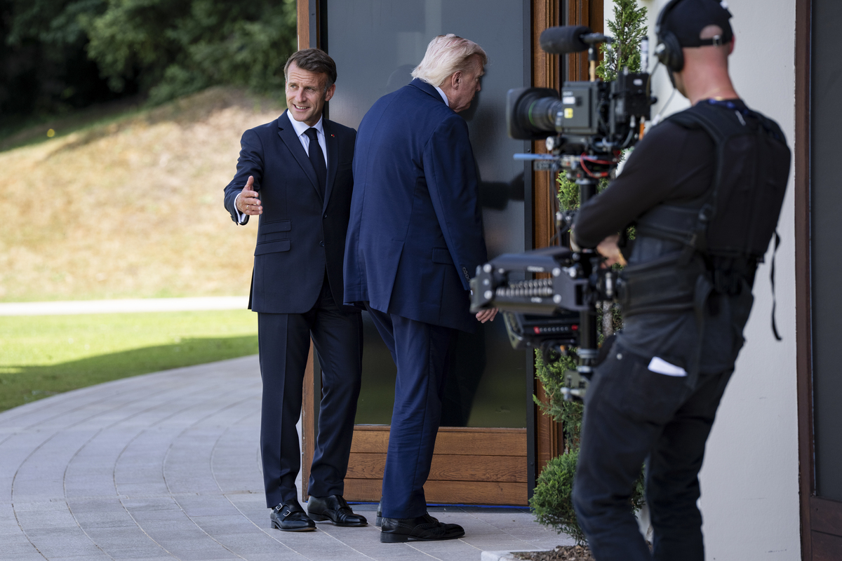 President Emmanuel Macron of France, left, with President Donald Trump after world leaders gathered for an official photo at the G7 Summit in Evian-les-Bains, France, June 16, 2026. (Haiyun Jiang/The New York Times)