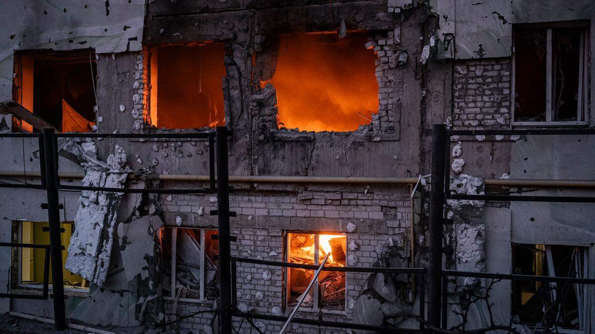A fire rages in an apartment block damaged by an overnight Russian drone strike in Kharkiv, Ukraine.