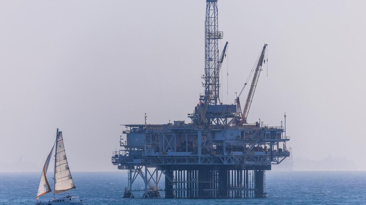 A sailboat cruises past platform Eva, an offshore oil drilling platform located approximately 2.8 miles off the coast of Huntington Beach, California, which was installed in 1963 and is currently operated by DCOR, LLC., on Friday, May 1, 2026. (Allen J. Schaben/Los Angeles Times/TNS)