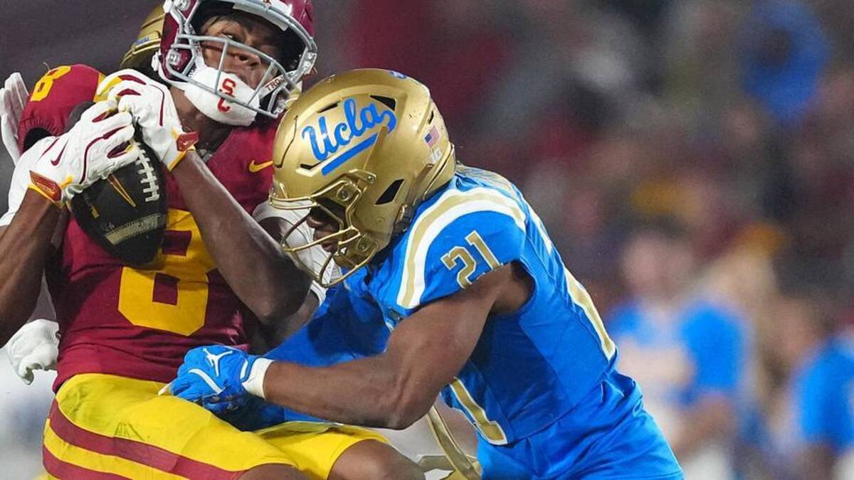  Nov 29, 2025; Los Angeles, California, USA; Southern California Trojans wide receiver Ja'Kobi Lane (8) catches the ball against UCLA Bruins defensive back Cole Martin (21) in the second half at United Airlines Field at Los Angeles Memorial Coliseum. Mandatory Credit: Kirby Lee-Imagn Images | Kirby Lee-Imagn Images 