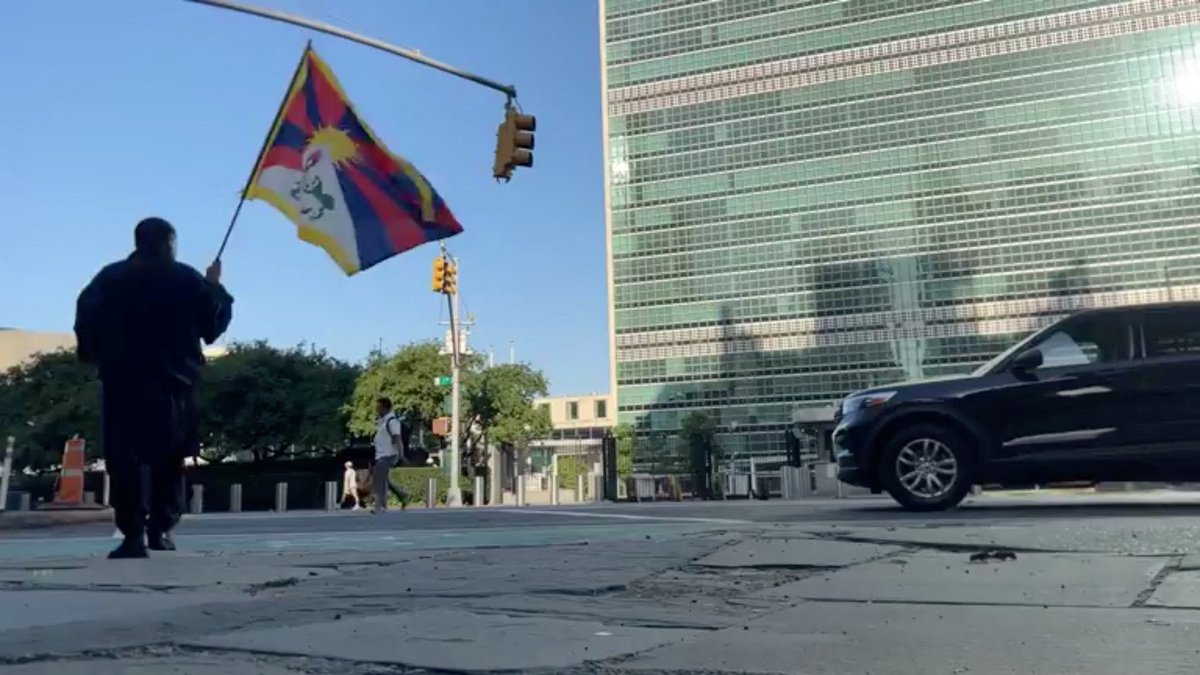 A man identified by Voice of Tibet, a media outlet of exiled Tibetans, as Tibetan activist Lobga Rangzen, walks carrying a Tibetan flag near the United Nations headquarters, before setting himself on fire in an appeal for Tibetan independence, in New York, U.S, July 2, 2026 in this still image obtained from social media video. Lobga Rangzen via Facebook/via REUTERS