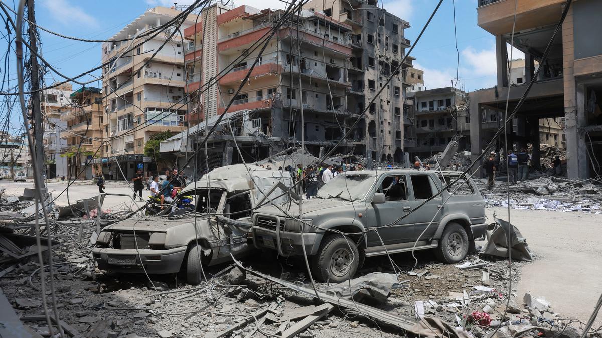 People gather at the site of an Israeli strike carried out last week in Tyre, Lebanon, on Tuesday. Israel and Lebanon agreed to implement a ceasefire to end hostilities, the Trump administration said on Wednesday, in a boost to hopes for a broader deal to end the U.S.-Israeli war on Iran.