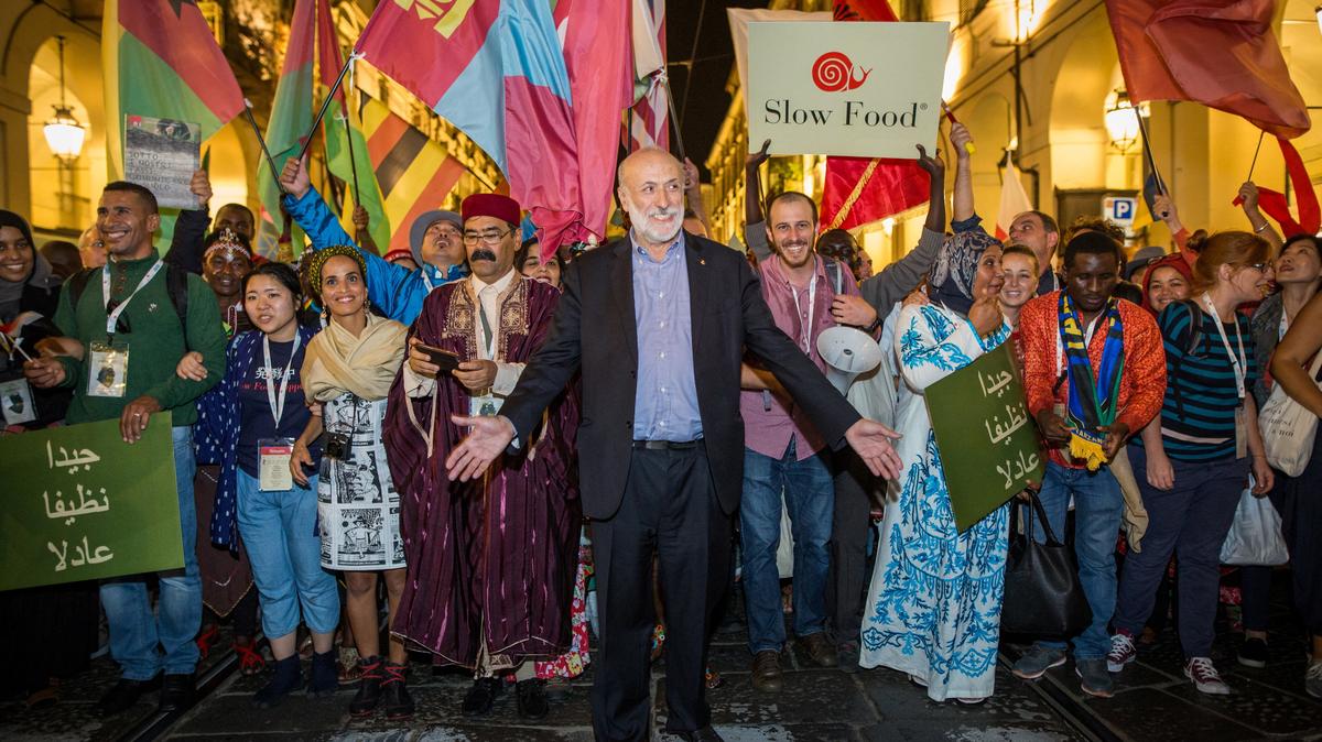 Carlo Petrini, founder of the Italian ‘Slow Food’ movement that promotes quality food, genuine ingredients and local produce, walks with participants during a Slow Food gathering in this undated handout picture. SLOW FOOD/Handout via REUTERS