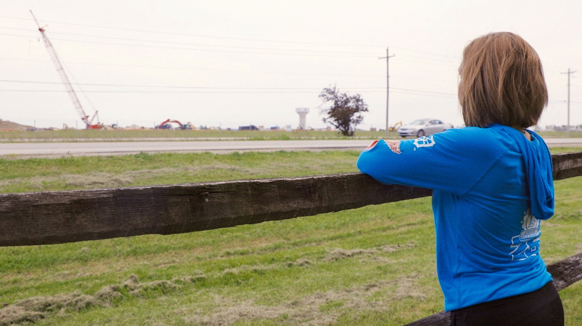 Daycare owner Breanne Kidd looks at construction on the data center across the street from her home in Middleton Township, Ohio, U.S., May 12, 2026. REUTERS/Eric Cox