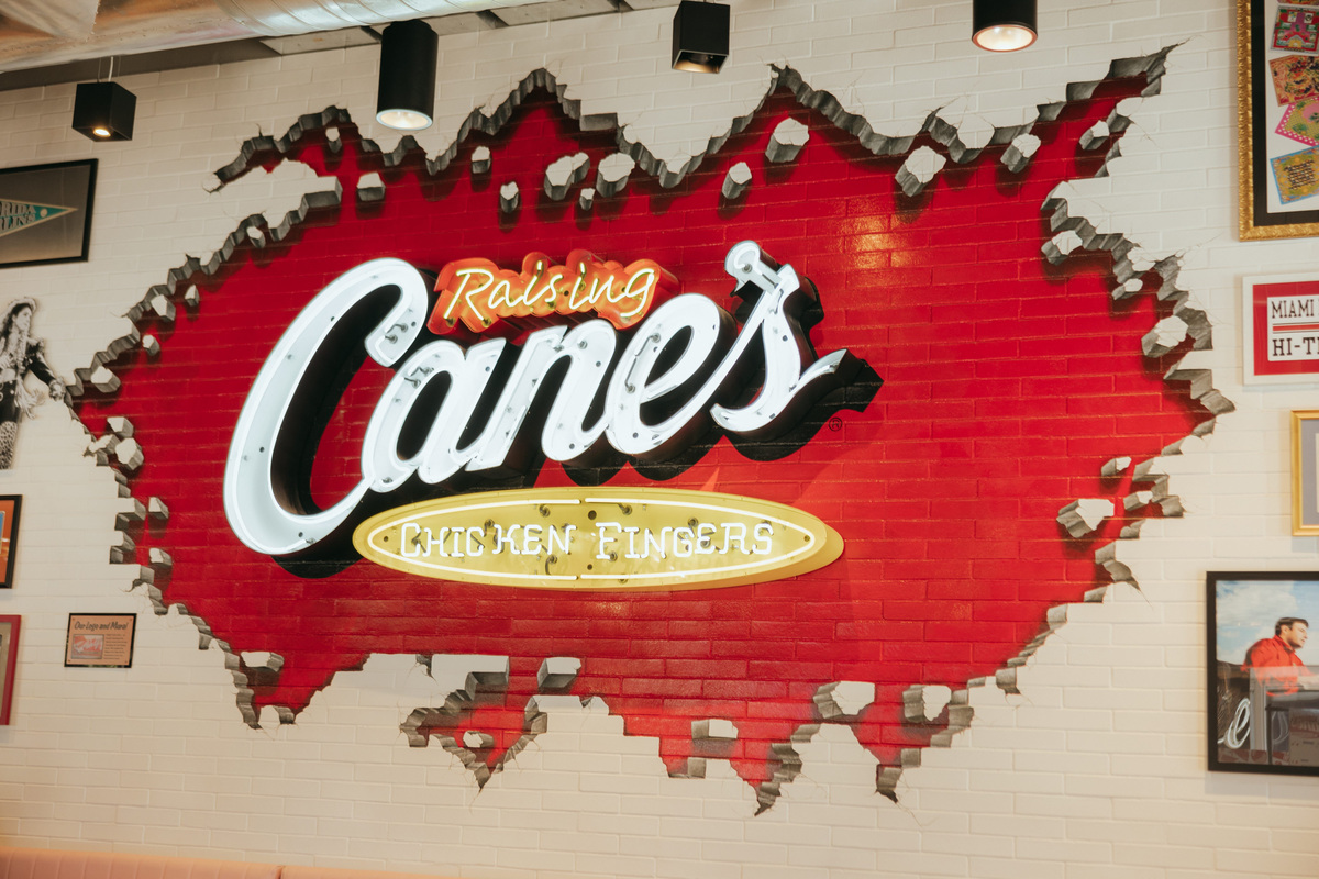 A brick sign at a Raising Cane's location.