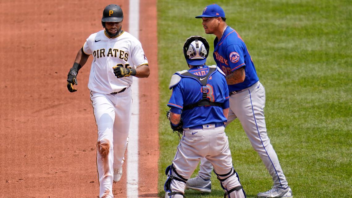 Pittsburgh Pirates’ Gregory Polanco, left, scores past New York Mets starting pitcher Taijuan Walker, right, and catcher Tomas Nido on an infield hit by Kevin Newman and a fielding error during the first inning of a baseball game in Pittsburgh, Sunday, July 18, 2021. Three runs scored on the fielding error by Walker. (AP Photo/Gene J. Puskar)