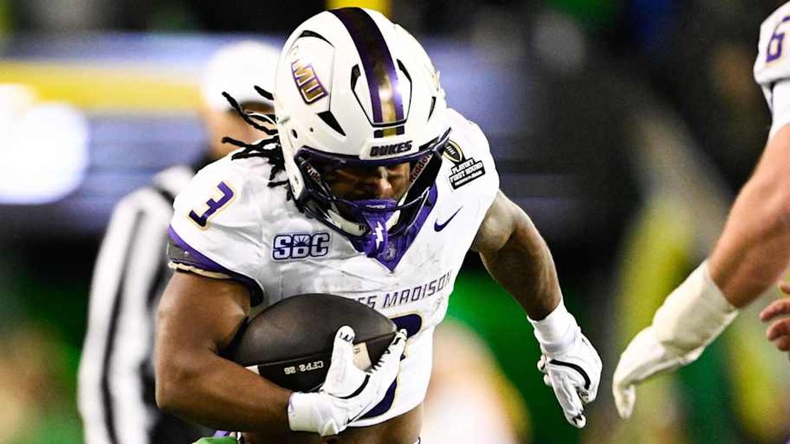  Dec 20, 2025; Eugene, OR, USA; James Madison Dukes running back Wayne Knight (3) rushes as Oregon Ducks defensive back Aaron Flowers (21) defends during the second quarter at Autzen Stadium. Mandatory Credit: Troy Wayrynen-Imagn Images | Troy Wayrynen-Imagn Images 