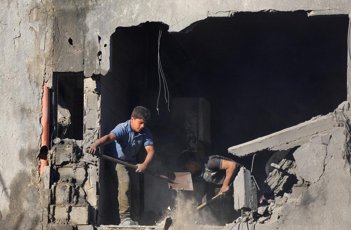 Palestinians work at the site of an Israeli strike on a house, which was pre-warned by the Israeli military to evacuate before the strike was carried out late on Thursday, at Shati (Beach) refugee camp in Gaza City, May 29, 2026. REUTERS/Dawoud Abu Alkas