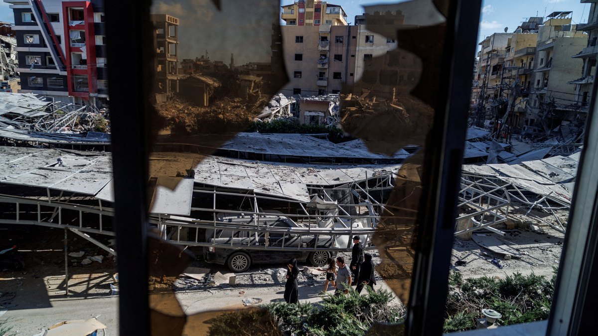 People walk past rubble at the site of an Israeli strike following a deal between the U.S. and Iran in Tyre, southern Lebanon, June 16, 2026. REUTERS/Zohra Bensemra