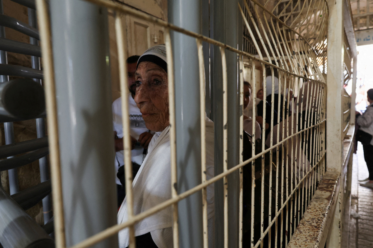 Palestinians wait at an Israeli checkpoint as they head for prayer at the Ibrahimi Mosque, also known as the Cave of Patriarchs, in the old city of Hebron, in the Israeli-occupied West Bank, June 17, 2026. REUTERS/Ammar Awad