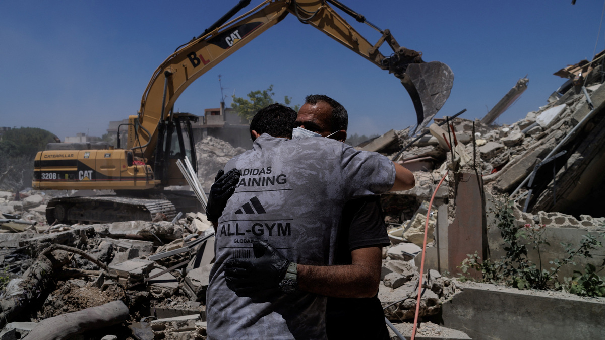Rescuers embrace as they work at the site of an Israeli air strike in Barish, Tyre district, Lebanon, June 20, 2026. REUTERS/Zohra Bensemra