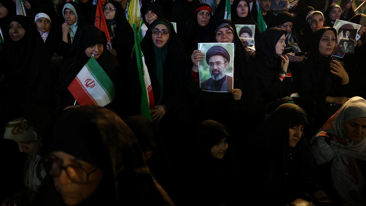A woman holds a picture of Iran’s new Supreme Leader, Mojtaba Khamenei, during a rally in Tehran, Iran, May 6, 2026. Majid Asgaripour/WANA (West Asia News Agency) via REUTERS