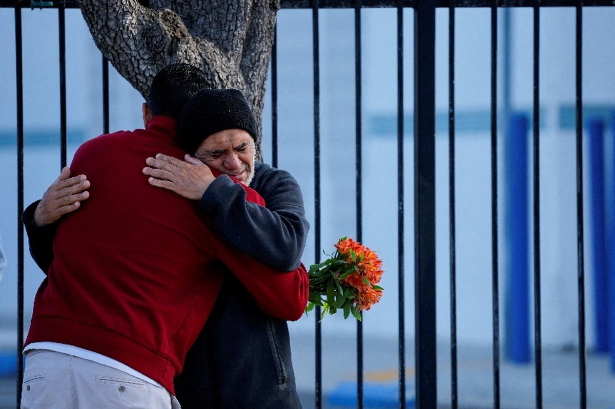 People hug outside the Islamic Centre of San Diego, the morning following a shooting, in San Diego, California, U.S, May 19, 2026. REUTERS/ Mike Blake