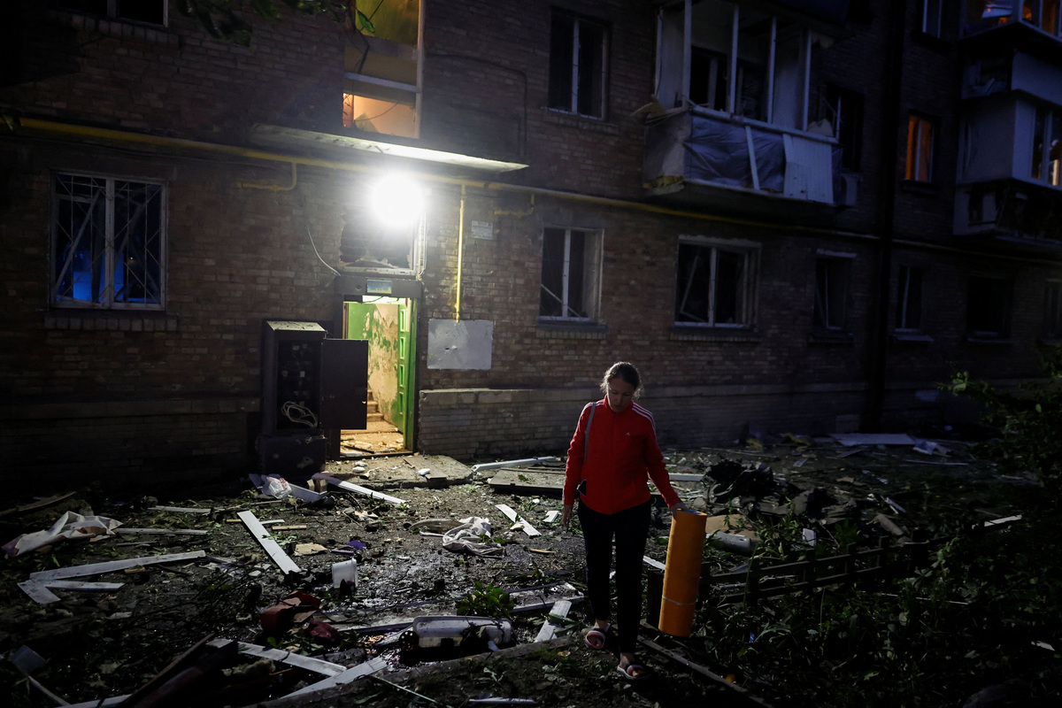 A resident walks outside a damaged building during Russian missile strikes, amid Russia’s attack on Ukraine, in Kyiv, Ukraine July 19, 2026. REUTERS/Thomas Peter
