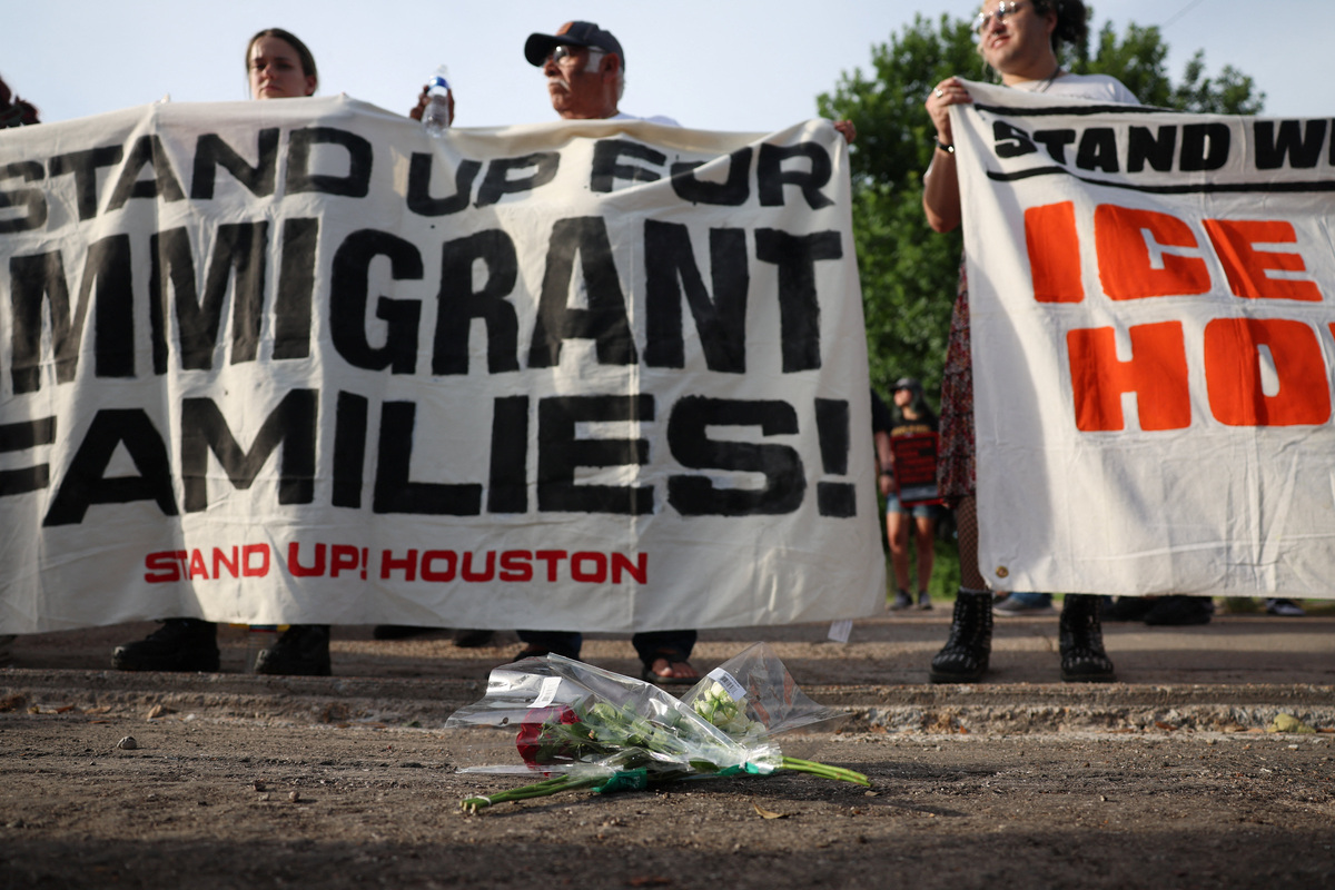 Flowers lie on the ground as people hold a vigil after the fatal shooting of Mexican motorist Lorenzo Salgado Araujo by an ICE agent in Houston, Texas, U.S., July 8, 2026.  REUTERS/Antranik Tavitian